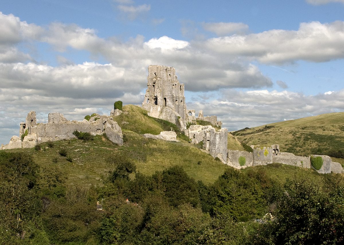 Corfe Castle ruins rising above the village of Corfe Castle in Dorset